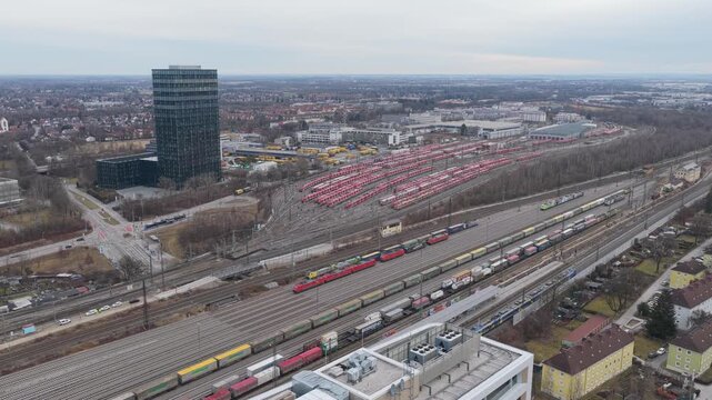 Drone footage of a train depot in Munich, Germany, showing rows of parked trains and rail tracks forming geometric patterns in an active railway facility.