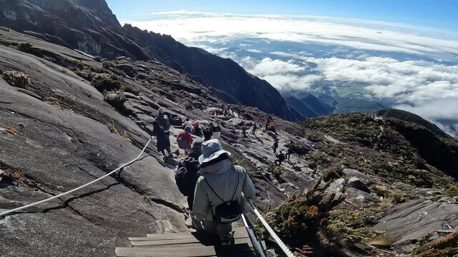 Group of tourist while descending from Mt.Kinabalu summit. Mt.Kinabalu is the highest mountain in Borneo and Malaysia.