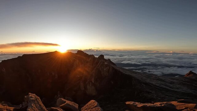 Footage of sunrise over Low's peak (4,095 m) the highest point on Mt.Kinabalu, Malaysia. Mount Kinabalu is the highest mountain in Malaysia and Borneo, standing at 4,095 meters in Sabah, Malaysia.