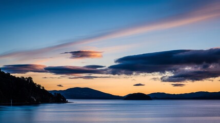 Fototapeta premium wholeness. Golden sunrise over a calm horizon, first light on clouds, serene landscape with deep blue sky. travel magazines, destination branding, designed for outdoor magazines and nature guides. 