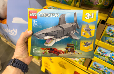 Fototapeta premium LEGO Creator 3 In 1 Shark Toy Building Set Box Held In Hand At Costco Warehouse Aisle