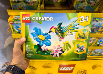 Fototapeta premium LEGO Creator 3 In 1 Tropical Bird Toy Building Set Box Held In Hand At Costco Warehouse Aisle
