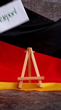 Paper note with words EXPORT on National symbol of Germany. German wave silky flag background. Concept of economy industry global market international shipping
