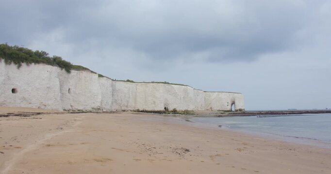 Extra wide shot of kingsgate beach with white cliffs and the King's gate arch in background
