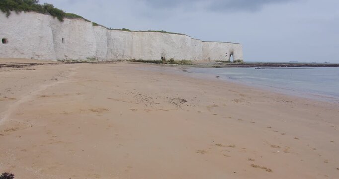 Extra wide shot of kingsgate beach with white cliffs and the King's gate arch in background at low tide