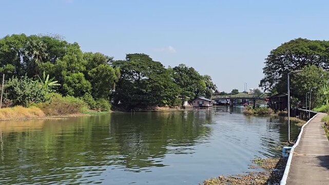 Khlong Canal in Pathum Thani with Elevated Concrete Walkway Along Waterway