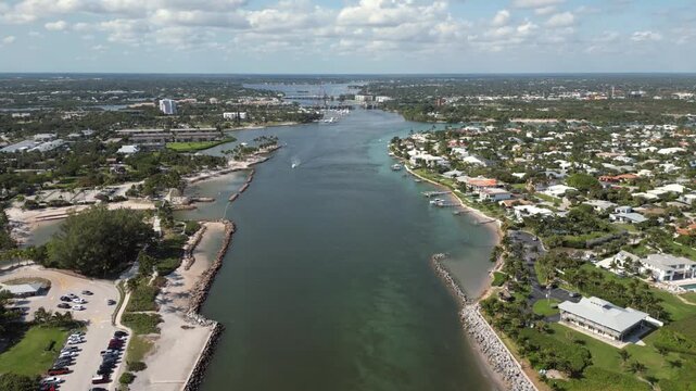 Aerial View of Jupiter Florida's Loxahatchee River Inlet with Red Lighthouse and Waterfront Homes