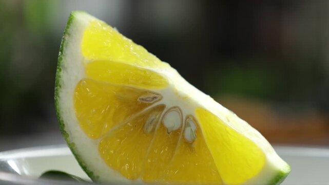 Peeled mandarin orange segment on blurry background. Orange Slices on Wooden Table. 4K Fruit
