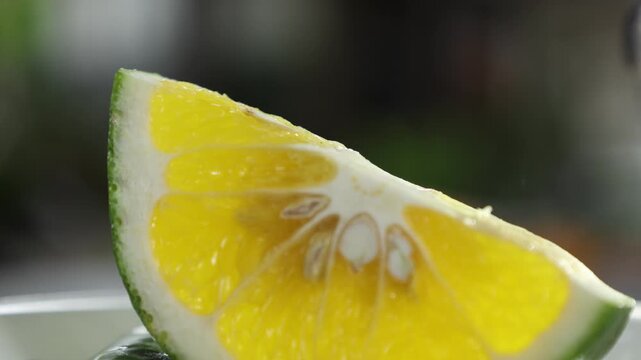 Peeled mandarin orange segment on blurry background. Orange Slices on Wooden Table. 4K Fruit
