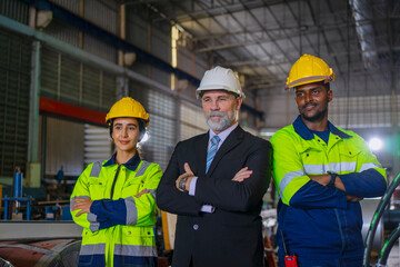 White collar worker and blue collar workers are working together at metal sheet factory.