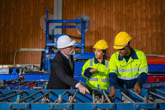 White collar worker and blue collar workers are working together at metal sheet factory.