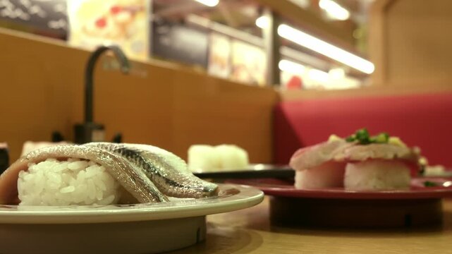 Blurred interior of conveyor belt sushi restaurant with warm lighting, kaiten-zushi atmosphere background in Japan for food and travel concepts