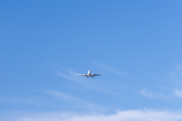 Front view of a commercial airplane on landing approach at Iona Beach Regional Park in Vancouver Canada