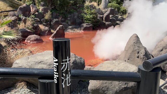 Dramatic blood-red hot spring with thick white steam and erupting sounds at Chinoike Jigoku in winter, Beppu, Oita, Japan (4K)