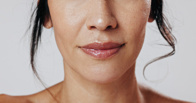 Woman, lips and beauty with makeup in studio for cosmetics or facial on a white background. Closeup, female person or model with mouth, gloss or glow up for shine, cosmetology or skincare aesthetic