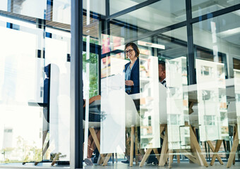 Obraz premium Business people, office and meeting with corporate group for planning, budget or briefing. Low angle, professional men and women together for brainstorming, teamwork and discussion by glass window