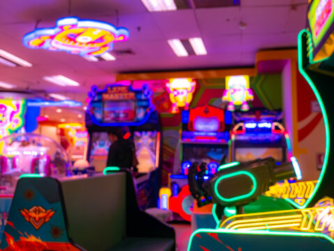 Interior view of colorful arcade game center with neon lights and gaming machines, vibrant entertainment zone