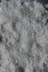Obraz premium Close up of white sea salt crystals texture, mineral powder background.