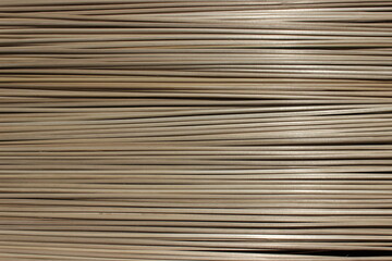Fototapeta premium Row of dried bamboo sticks, natural wooden sticks background for handcraft.
