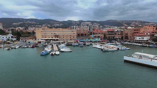 Drone Shot Of Tourists Ferry Boat Departing From Batroun Marina Bay To Open Sea, Lebanon