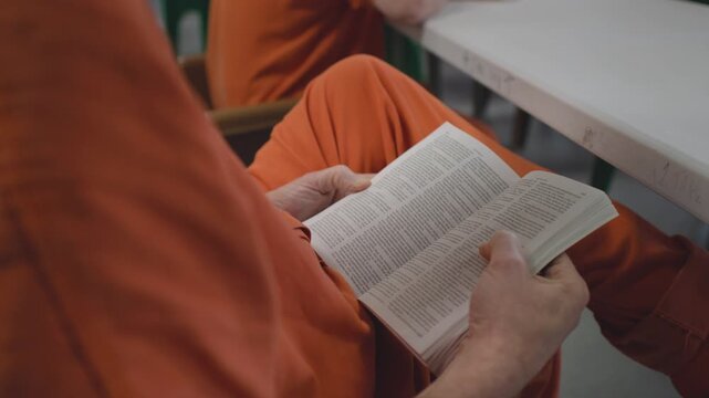 Inmate Reading Bible in Prison Cell &ndash; Faith and Reflection During Incarceration