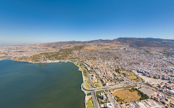 Izmir, Turkey. Aerial view of modern Bayrakli promenade and park with rekreasyon alani recreational zones along the coast. Bisikletli mola terasi and pedestrian paths. Summer daytime. Aerial view.