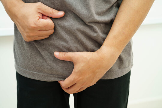 Hernia, Asian man stomach ache, abdominal pain and urology problem health.