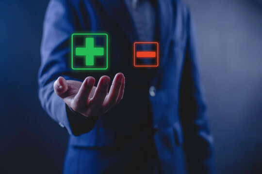Businessman comparing positive and negative choices with plus and minus symbols, representing decision making, business evaluation, risk assessment, strategic planning, and problem solving concept.
