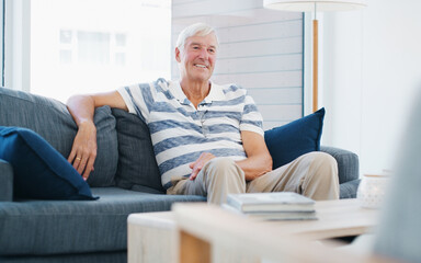 Fototapeta premium Relax, smile and thinking with old man on sofa in home living room for me time, retirement or wellness. Comfortable, morning and reflection with happy senior in apartment for optimism or satisfaction