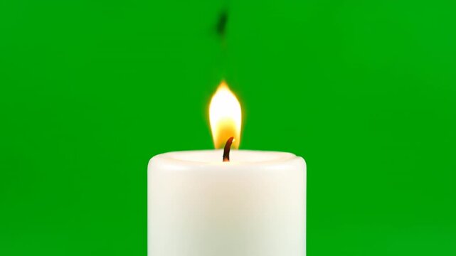 A wide, stubby candle with a vibrant, flickering flame, isolated on green screen decorative, rustic, energy
