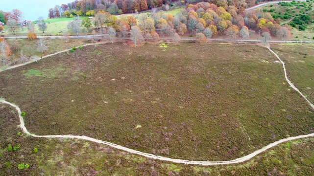 Aerial drone shot of hiking trails winding through wetland landscape and open heath area at Fjaras Bracka nature reserve in Sweden