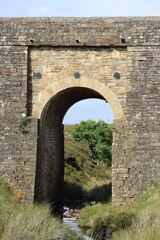 Old stone arch bridge in a moorland landscape