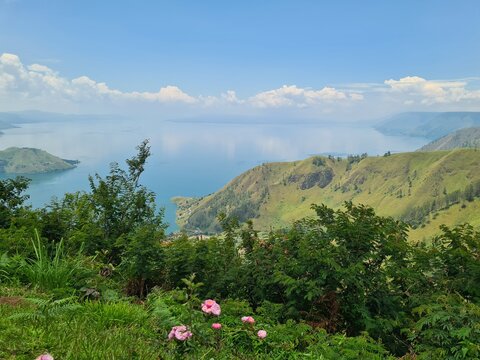 Breathtaking panoramic view of Lake Toba in North Sumatra, Indonesia. The world's largest volcanic lake features Samosir Island and is a premier destination for tourism and nature.