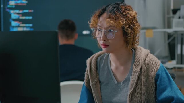 software engineer and programmer collaborating on software development on multiple monitors at night office,developer write prompt AI bot IT app program,coding ai agent,data analytics in tech office.