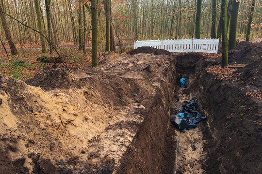Construction of a trench in a forest area during fall season