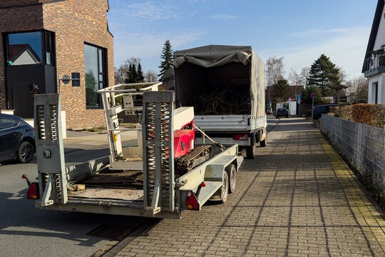 Truck and trailer parked on the street with items for transport