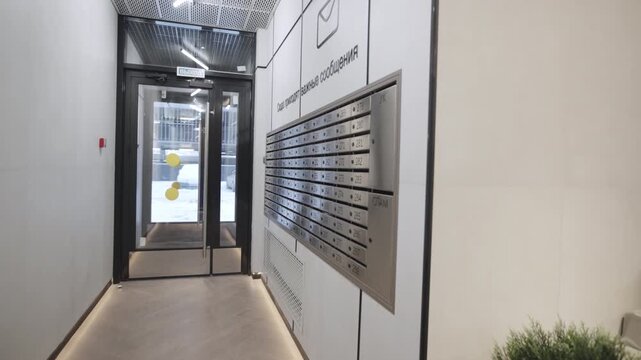 Functional design merges postal service with stylish entrance transparency creating welcoming transition space. Scene appears balanced