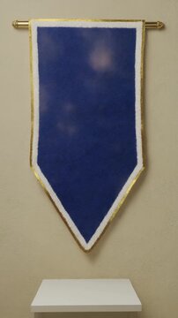 The Generic Pennant. Soccer/Football Merchandise Mockup (No Brand, No Logo). Fan Merchandise. A plain triangular felt pennant in royal blue with a white border, hanging against a textured ivory wall

