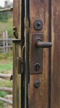 Rustic wooden door with metal hardware.