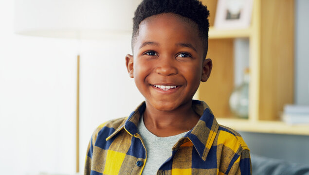 Happy, black child or boy with positive attitude in home for childhood development or growth. Person, kid or smile with confidence, good behavior or innocence for holiday, weekend or break in house