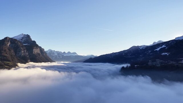 Aerial view of Swiss mountains and clouds near Walensee, serene and vast