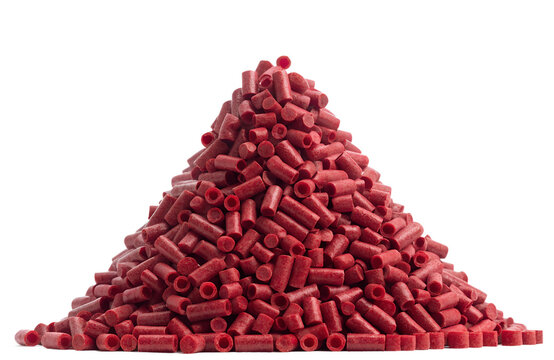 Heaped Pile of red Polymer Resin Granules for Plastic Manufacturing Isolated on White