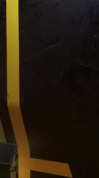 Workers are present at a construction site with a black wall. A yellow line runs vertically along the wall. Equipment is scattered around during daylight hours.