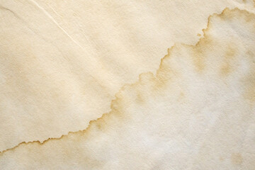 Old vintage paper texture background with aged stains and antique yellowed parchment effect