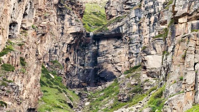 4K Landscape shot of dried waterfall during the summer season as seen from Sural Bhatori in Pangi Valley, Himachal Pradesh, India. Dried waterfall due to lack of rain in the summer season in Himalayas