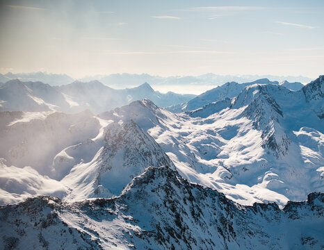 Aerial view of snow-capped mountains piercing the sky, their peaks frosted with winter's icy touch, Hochgurgl, Tirol, Austria.
