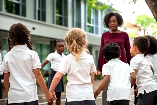 Children playing outside with teacher.