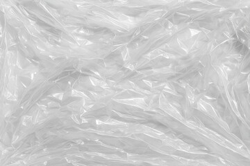 Obraz premium Crumpled plastic wrap texture transparent glossy plastic film background for design