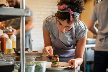 Chef garnishing gourmet dish