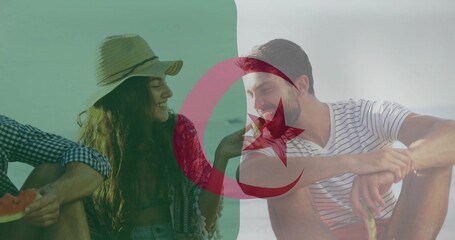 Naklejka premium Sharing trio passing watermelon at beach wearing straw-hat patterned-wrap striped-tee Algerian flag